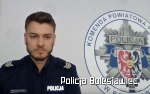 Umundurowany policjant, w tle logo bolesławieckiej komendy.